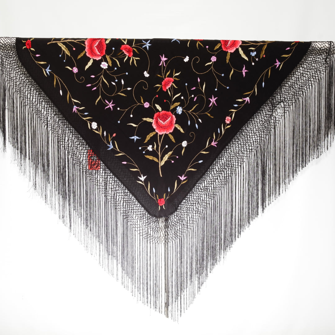 Black scarf with floral embroidery and fringe on a white background