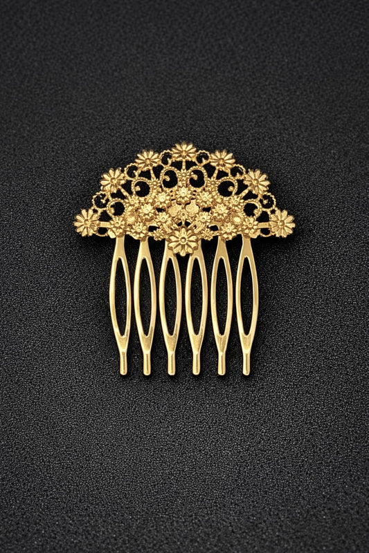 Gold hair comb with floral design on a black background