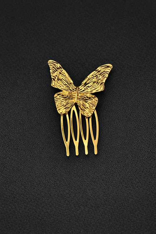 Gold butterfly hair comb on a black background