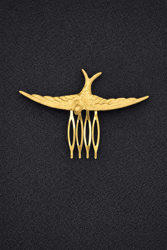 Gold comb with decorative design on a black background