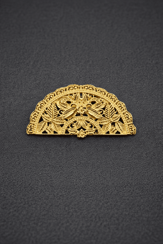Gold lace hair clip on a black background