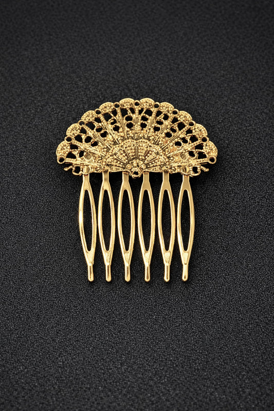 Gold hair comb with intricate design on a black background