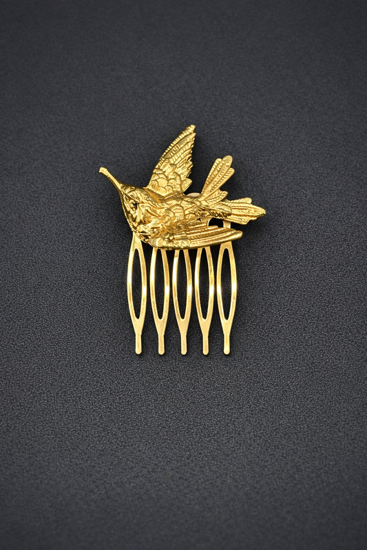 Gold hummingbird comb on a black background