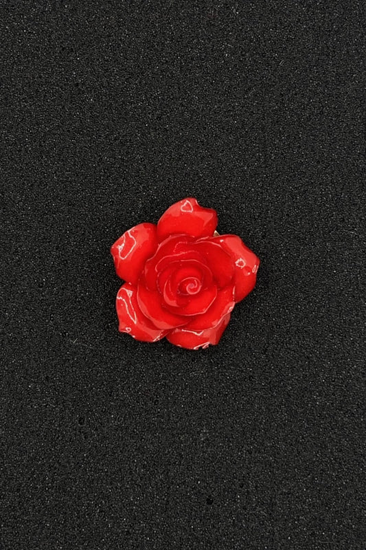 Red rose-shaped object on a black background